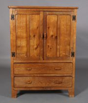 AN ADZED OAK COMPACTUM HAVING TWO TWIN INDENTED PANEL DOORS with angular bar handles above two