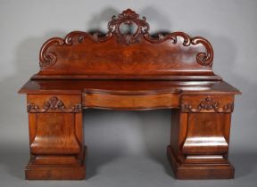 A VICTORIAN FIGURED MAHOGANY PEDESTAL SIDEBOARD, the raised back with carved shell foliate and C-