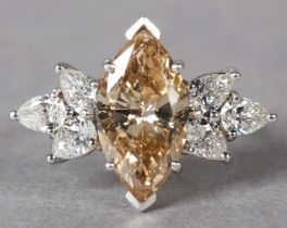 A DIAMOND CLUSTER RING, claw set to the centre with a marquise fancy Champagne yellow diamond