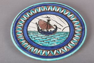 A BURMANTOFTS FAIENCE WALL PLATE the centre painted with a galleon at sea within a petal border,