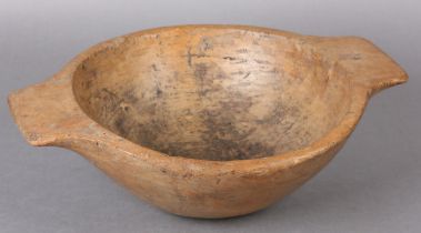 A 19TH CENTURY TURNED SYCAMORE DAIRY BOWL with twin handles, 36cm over handles x 12cm high