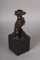 A BRONZE FIGURE OF A DACHSHUND modelled sitting up begging, by Holger Wederkinch, signed and