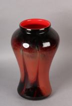 A MONART ART GLASS VASE of baluster form having a dark red, orange and green ground with glossy
