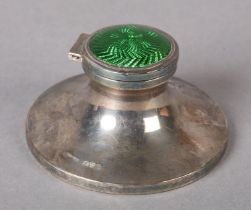 A GEORGE V SILVER AND GREEN ENAMEL 'CAPSTAN' INKWELL, of circular spreading base, Chester 1913,