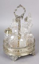 A VICTORIAN SILVER PLATED SIX BOTTLE BREAKFAST CRUET, the oval basket of pierced design with gadroon