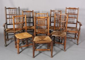 A 19TH CENTURY MATCHED SET OF EIGHT ELM SPINDLE BACK AND RUSH SEATED CHAIRS, on rounded legs with