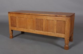 A THOMPSON OF KILBURN 'MOUSEMAN' OAK BLANKET BOX, having an adzed top above a six indented panel