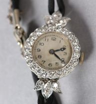 A LADY'S DIAMOND SET manual wristwatch in platinum circa 1950, Swiss jewelled lever movement by PWC,