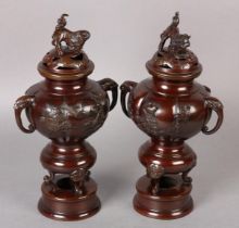 A PAIR OF JAPANESE BRONZE INCENSE BURNERS, Meiji period, the covers pierced with clouds having dog