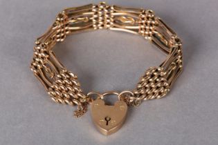 A VICTORIAN GATE BRACELET in 9ct rose gold, each four bar link with a central square knot, padlock