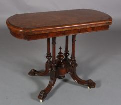 A VICTORIAN FIGURED WALNUT CARD TABLE, the oblong fold-over top lined in baise, on four fluted and