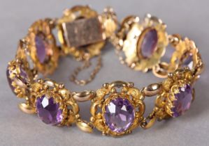 A VICTORIAN AMETHYST BRACELET in 9ct rose gold, each pieced scroll and beaded link set to the centre
