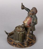 A MID 19TH CENTURY GERMAN COLD PAINTED METAL INKWELL cast as a gentleman sitting drinking wine, a