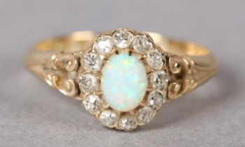A VICTORIAN OPAL AND DIAMOND CLUSTER RING in 18ct gold, Birmingham 1897, the oval cabuchon stone