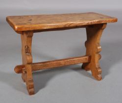 A THOMAS WHITTAKER OF LITTLEBECK 'GNOME MAN' OAK TABLE OR STOOL, rectangular, on shaped refectory