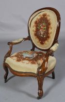 A VICTORIAN CHILD'S ROSEWOOD ARMCHAIR having an encircling frame, needlework upholstered oval