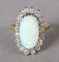 AN OPAL AND DIAMOND CLUSTER RING in 18ct yellow and white gold, claw set to the centre with an