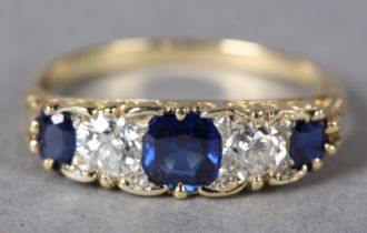 A SAPPHIRE AND DIAMOND FIVE STONE RING c1930 in 18ct gold, the graduated oval facetted sapphire