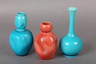 A BURMANTOFTS VASE HAVING PINCHED SIDES with waisted neck in turquoise glaze 13cm high, another pink