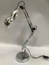 A chrome angle poise lamp