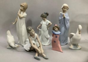 A collection of seven Nao figures including Girl Praying, Ballerina, Girl Yawning, two Geese and a