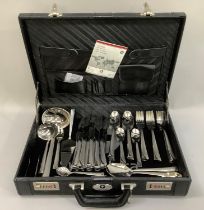 A suite of stainless steel cutlery by Swiss Jura, twelve place settings including table knives and