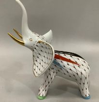 A Hollohoza Hungary porcelain figure of an elephant with hand painted net decoration having gilt