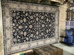 A large super Keshan carpet, the dark blue/black ground with all over trailing flowerheads and