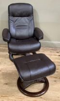 A brown leather swivel armchair and footstool in the style of Stressless