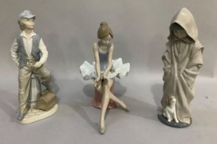 Three Nao figures including a boy in a hooded cloak with puppy, a ballerina, a shoe shine boy, 26cm,