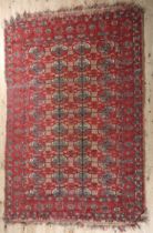 A Middle Eastern rug, the flatweave field of camel colour with thin red stripe, filled with ten rows