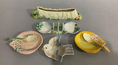A Clarice Cliff pattern no.980 toast rack, an ashtray in the form of a bird, a moulded planter,