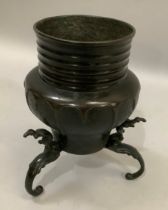 A Japanese bronze vase, horizontally fluted neck above an arch panelled body raised on three