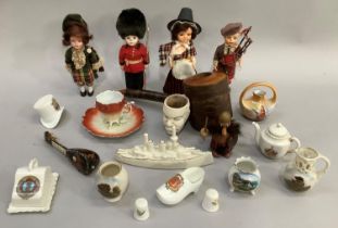 Five Scottish souvenir dolls, a collection of crestware including Knaresborough HMS Queen Elizabeth,