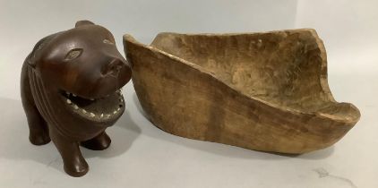 A teak carved figure of a lion, 16cm high, together with a rough hewn bowl