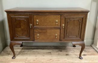 A 1920s mahogany sideboard having two drawers to the centre flanked by a cupboard to either side