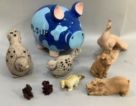 A large pottery pig in blue together with an earthware model of a peacock, two pottery birds, two