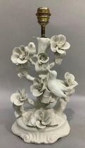 A blanc de chine porcelain table lamp, heavily moulded as birds and flowers, 44cm high