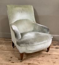 An Edwardian mahogany armchair upholstered in pale green velvet, on square tapered legs and with