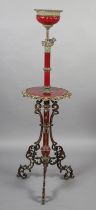 A LATE 19TH CENTURY CAST GILT METAL AND MAROON POTTERY STANDARD LAMP with circular tier and