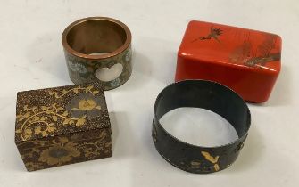 A Japanese bronze napkin ring incised and applied in yellow metal with frog and egret amongst