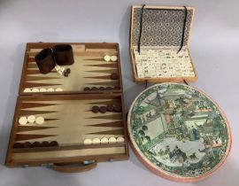 An early 20th century Chinese Mah Jong set with bone and bamboo counters together with a