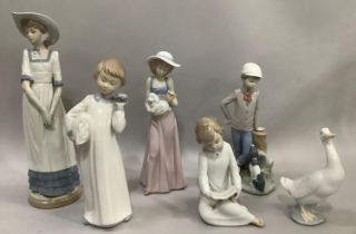 A collection of six Nao figures including a girl with bonnet and gloves, a boy with dog on tree