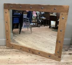 A metal studded pine framed wall mirror, 92.5cm x 118cm