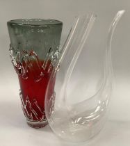 An unusual glass carafe and an art glass vase in red and clear having applied moulding, 29cm high