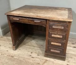 An early 20th century oak desk having a drawer flanked by four small drawers to the knee hole with