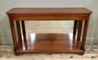 A cherry wood console table, cherry wood with canted corners, lower mirrored back and under tier, on