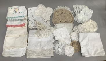 A quantity of vintage linen comprising five embroidered pillowcases, crochet table mats, and other