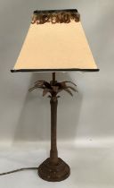 A bronze effect table lamp in the form of a palm tree, with shade