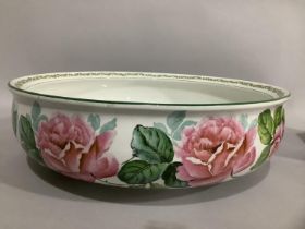 A Crescent china toilet bowl printed and painted with a continuous band of roses, 38cm diameter